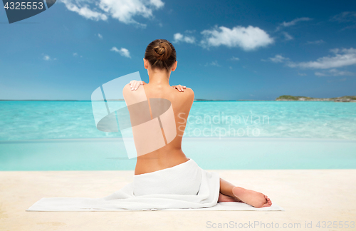 Image of beautiful woman in towel with bare back on beach