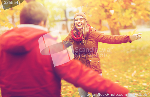 Image of happy young couple meeting in autumn park