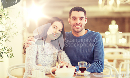 Image of happy couple drinking tea at restaurant