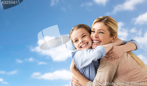 Image of happy family of girl and mother hugging over sky