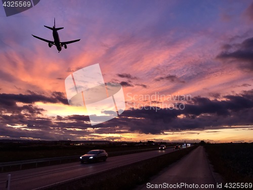 Image of A plane is approaching Stuttgart AIrport during a dramatic sunset