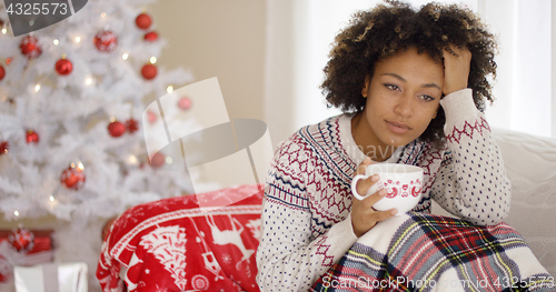 Image of Pensive young woman celebrating a lonely Christmas