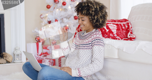 Image of Young woman having a video chat on her laptop