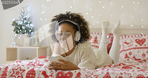 Image of Attractive young woman relaxing at Christmas