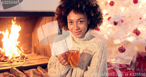 Image of Young woman drinking spicy lemon tea