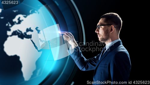 Image of businessman with earth hologram over black