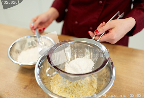 Image of chef with flour in bowl making batter or dough