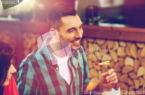 Image of happy man having dinner at restaurant