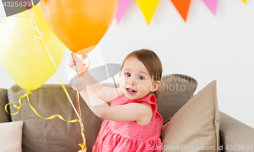 Image of happy baby girl on birthday party at home