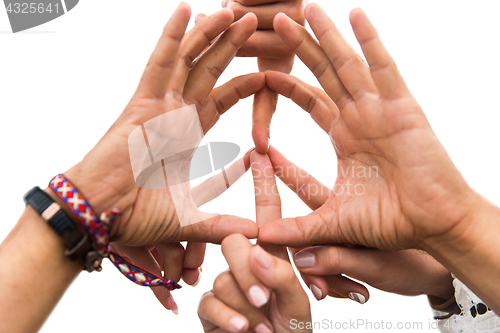 Image of hands of hippie friends showing peace sign