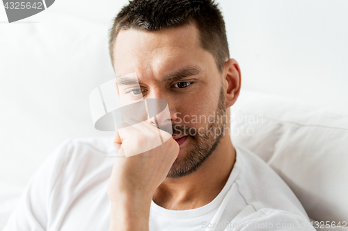 Image of close up of man in bed thinking