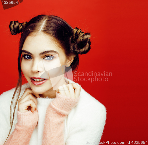 Image of young pretty emitonal posing teenage girl on bright red background, happy smiling lifestyle people concept 
