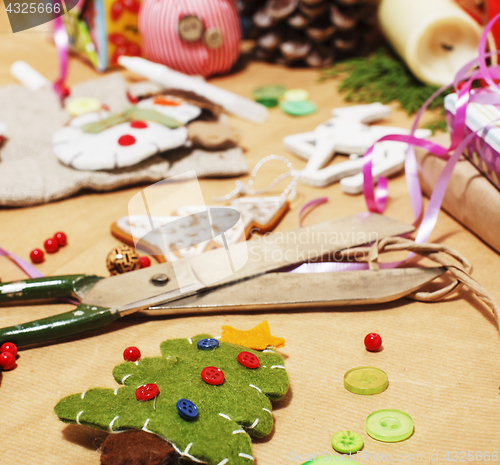 Image of lot of stuff for handmade gifts, scissors, ribbon, paper with countryside pattern, ready for holiday concept, nobody home 