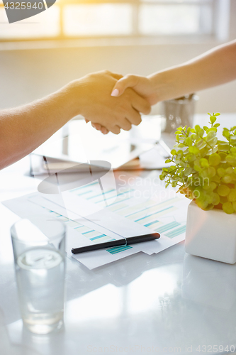 Image of Business partnership meeting concept. Image businessmans handshake. Successful businessmen handshaking after good deal. Horizontal, blurred background