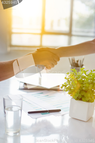 Image of Business partnership meeting concept. Image businessmans handshake. Successful businessmen handshaking after good deal. Horizontal, blurred background