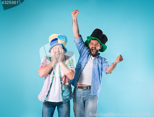 Image of The two football fans over blue
