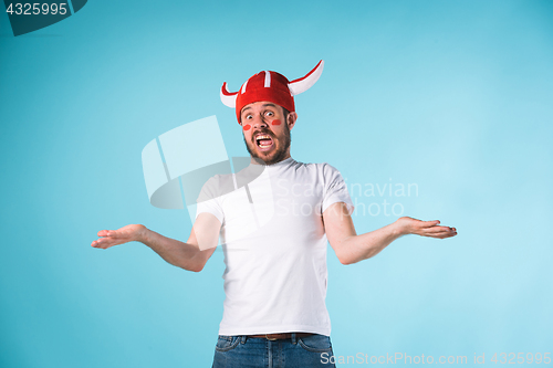 Image of The football fan over blue