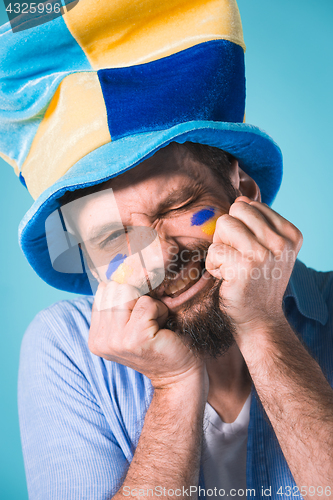 Image of The football fan over blue