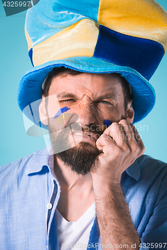 Image of The football fan over blue