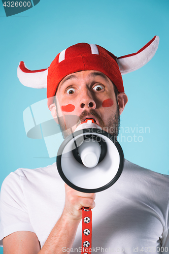 Image of The football fan over blue