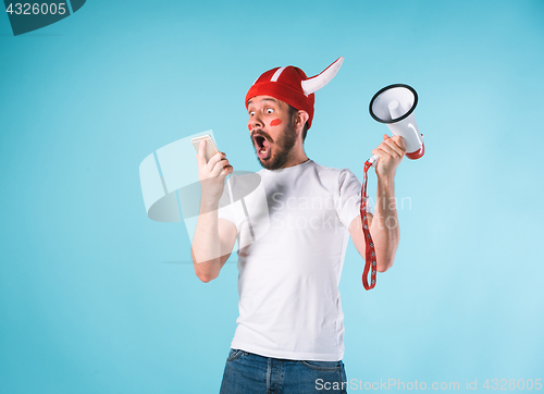 Image of The football fan over blue