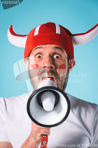 Image of The football fan over blue