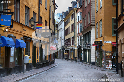 Image of STOCKHOLM, SWEDEN - AUGUST 20, 2016: View of narrow street and c