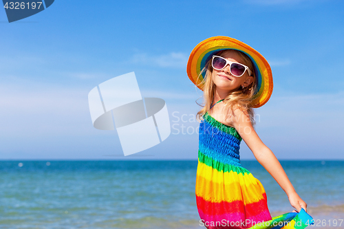 Image of Little girl  standing on the beach