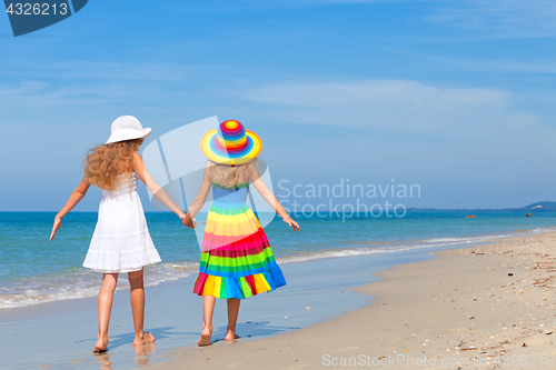 Image of happy children playing on the beach