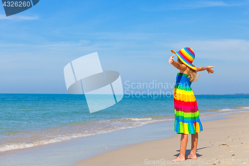 Image of Little girl  standing on the beach