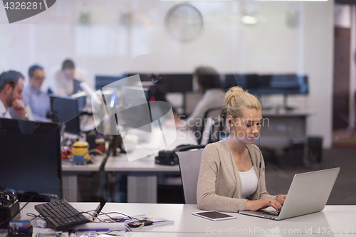 Image of businesswoman using a laptop in startup office