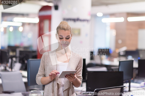 Image of Business Woman Using Digital Tablet in front of startup Office