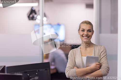 Image of Business Woman Using Digital Tablet in front of startup Office