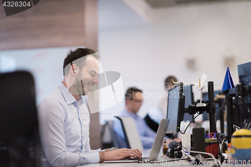 Image of businessman working using a laptop in startup office