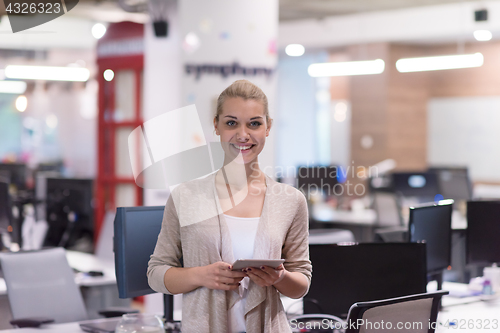 Image of Business Woman Using Digital Tablet in front of startup Office