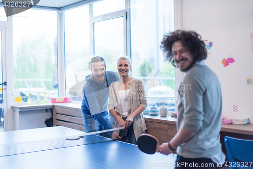 Image of startup business team playing ping pong tennis