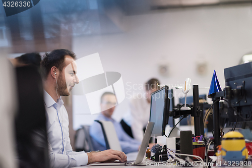 Image of businessman working using a laptop in startup office