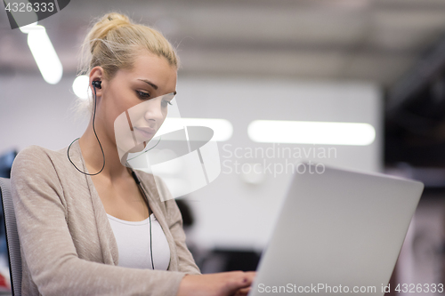 Image of businesswoman using a laptop in startup office