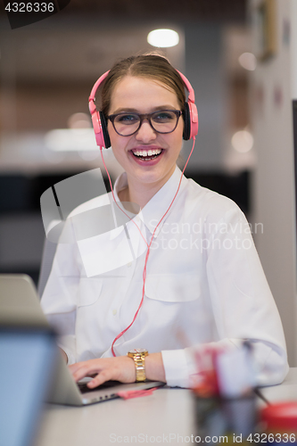 Image of businesswoman using a laptop in startup office