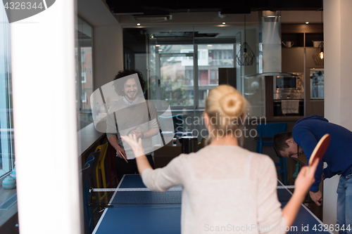 Image of startup business team playing ping pong tennis