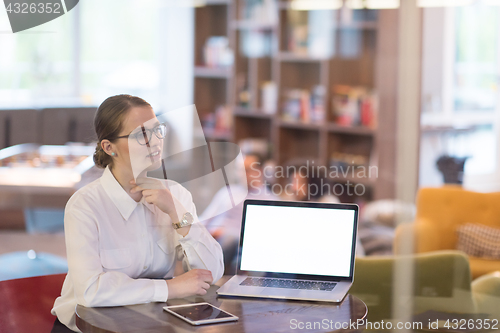 Image of businesswoman using a laptop in startup office