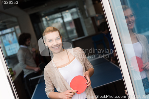 Image of startup business team playing ping pong tennis