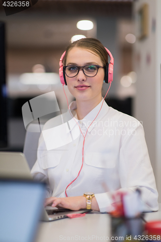 Image of businesswoman using a laptop in startup office