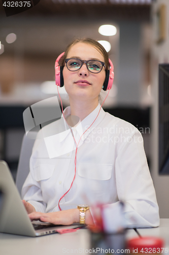 Image of businesswoman using a laptop in startup office