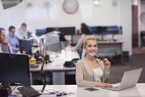 Image of businesswoman using a laptop in startup office