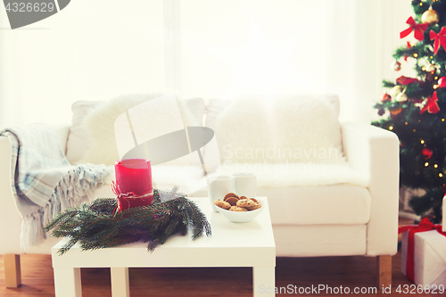 Image of sofa, table and christmas tree with gifts at home