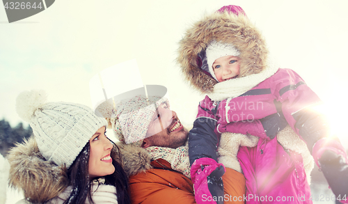 Image of happy family with child in winter clothes outdoors