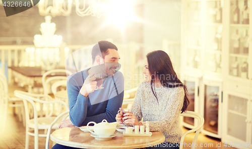 Image of happy couple drinking tea at cafe
