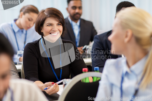 Image of business people at conference with papers