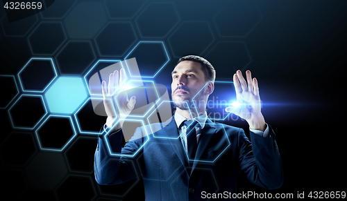 Image of businessman working with virtual network hologram